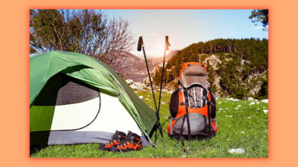 a picture showing a camp with a hiking sticks and a backpack laying on the grass while sun  mountains are shown in their background,