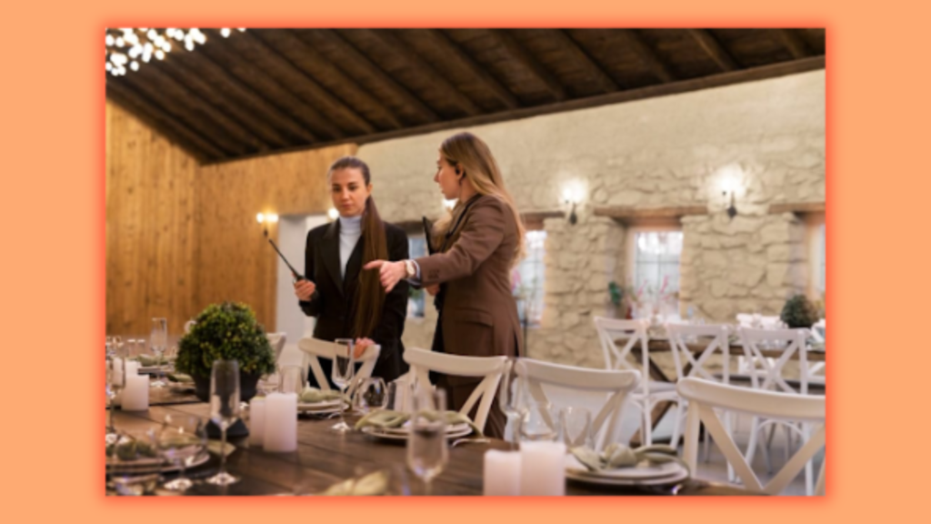 two women talking to each other while looking at the party table.