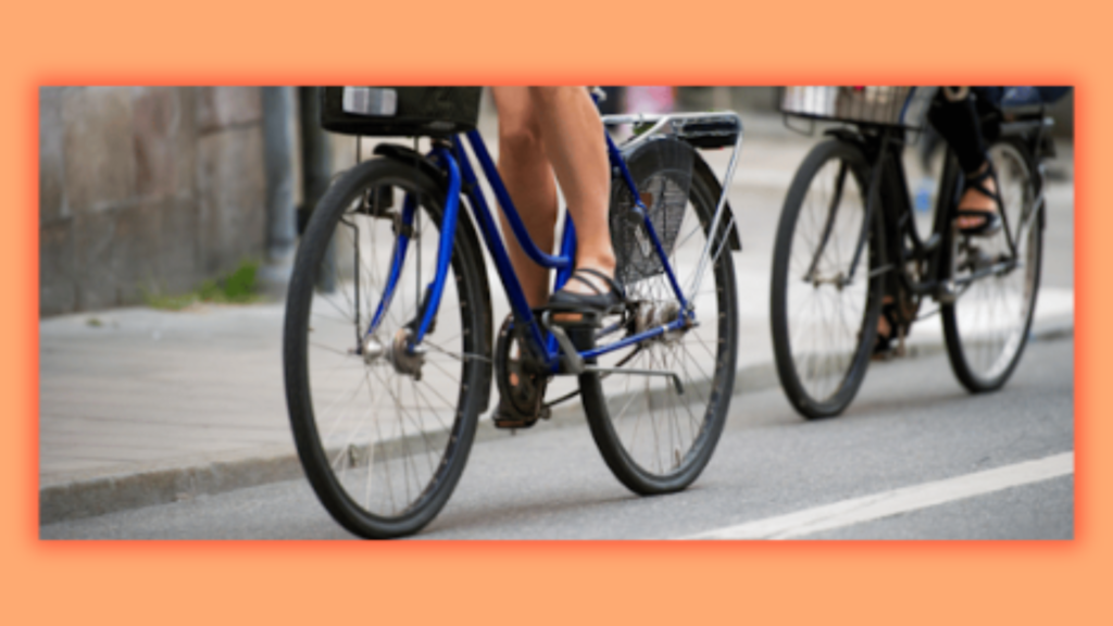 two person riding a bicycle on the road