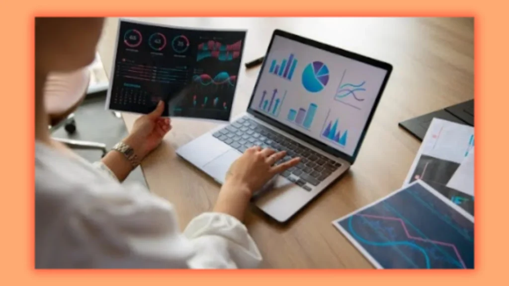 a image of a female with laptop with charts and analysis 