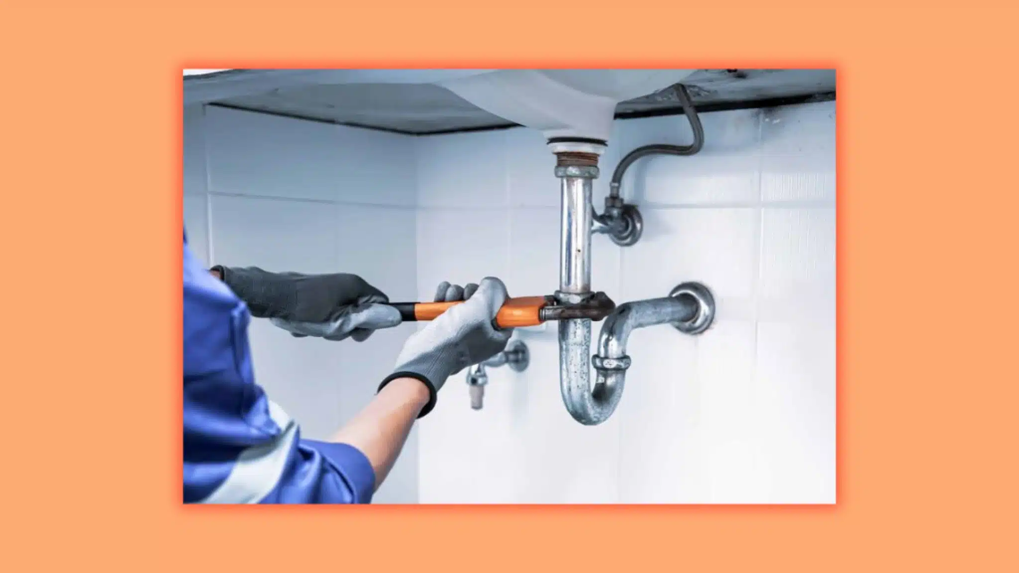 an image of a person's hands holding a screw wrench opening a pipe